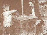 Calvin Frank and Betty Jean Dierberg are seated on the porch of their home located on Hog Hollow Road in the Missouri River Bottom. Courtesy of Judy Tappmeyer Dierberg.